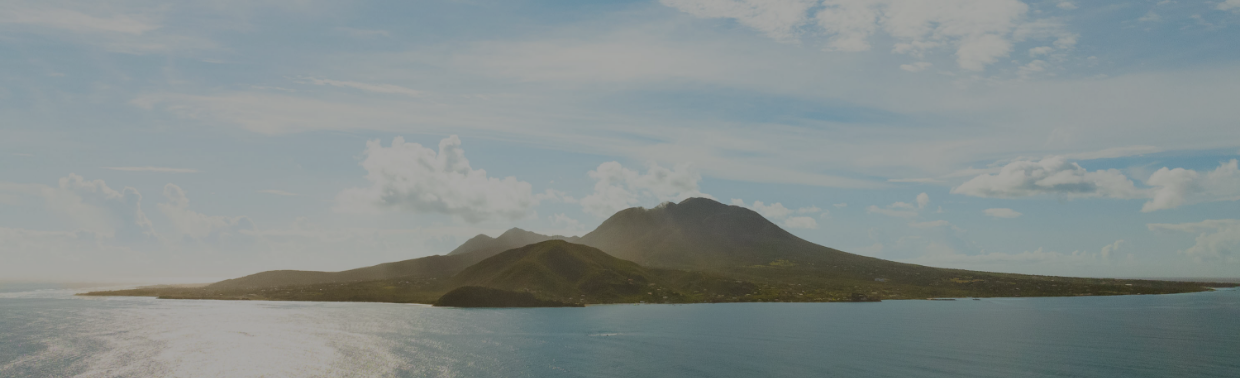 a body of water with mountains in the distance