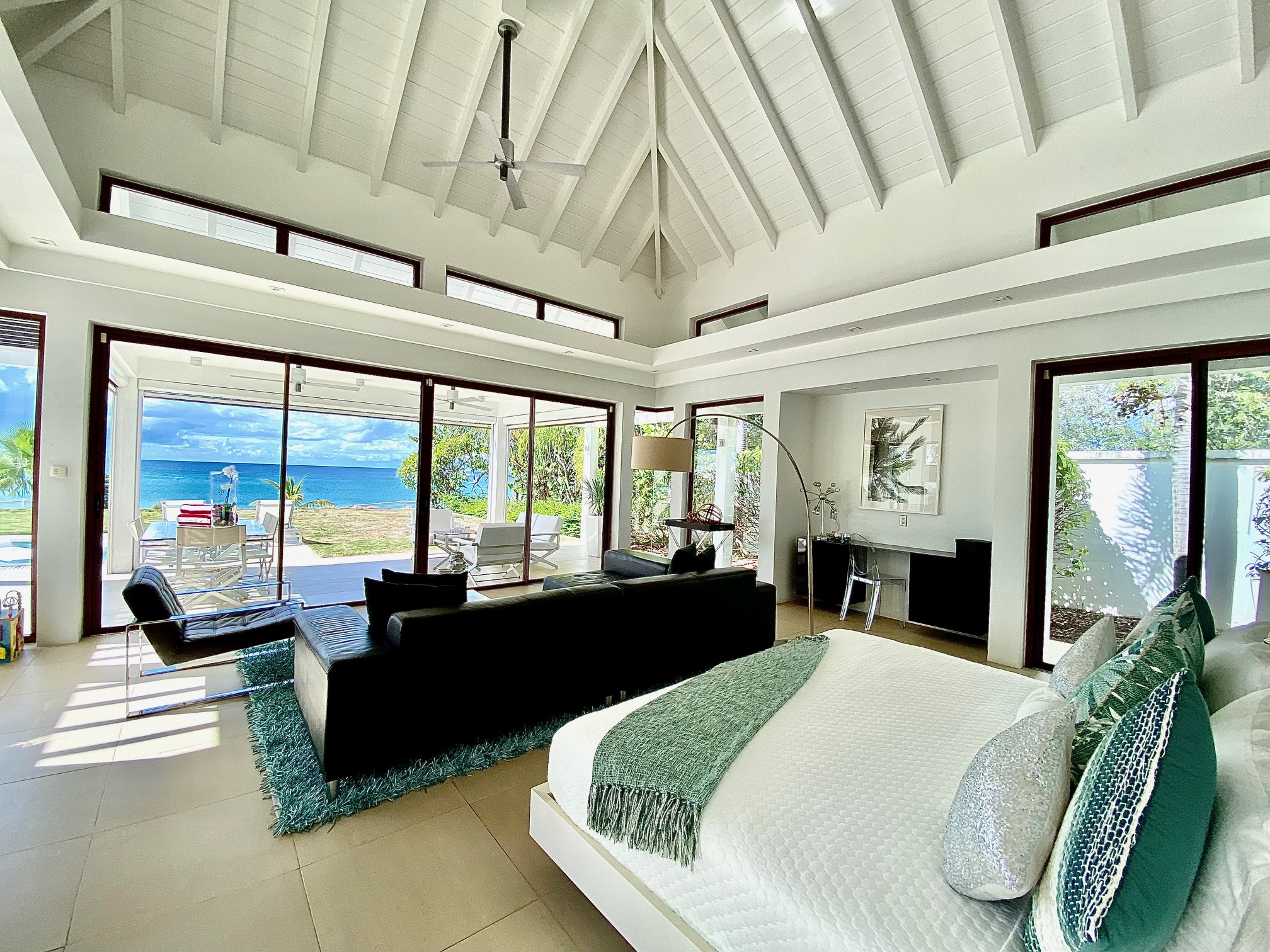 a bedroom with a large bed and a large window