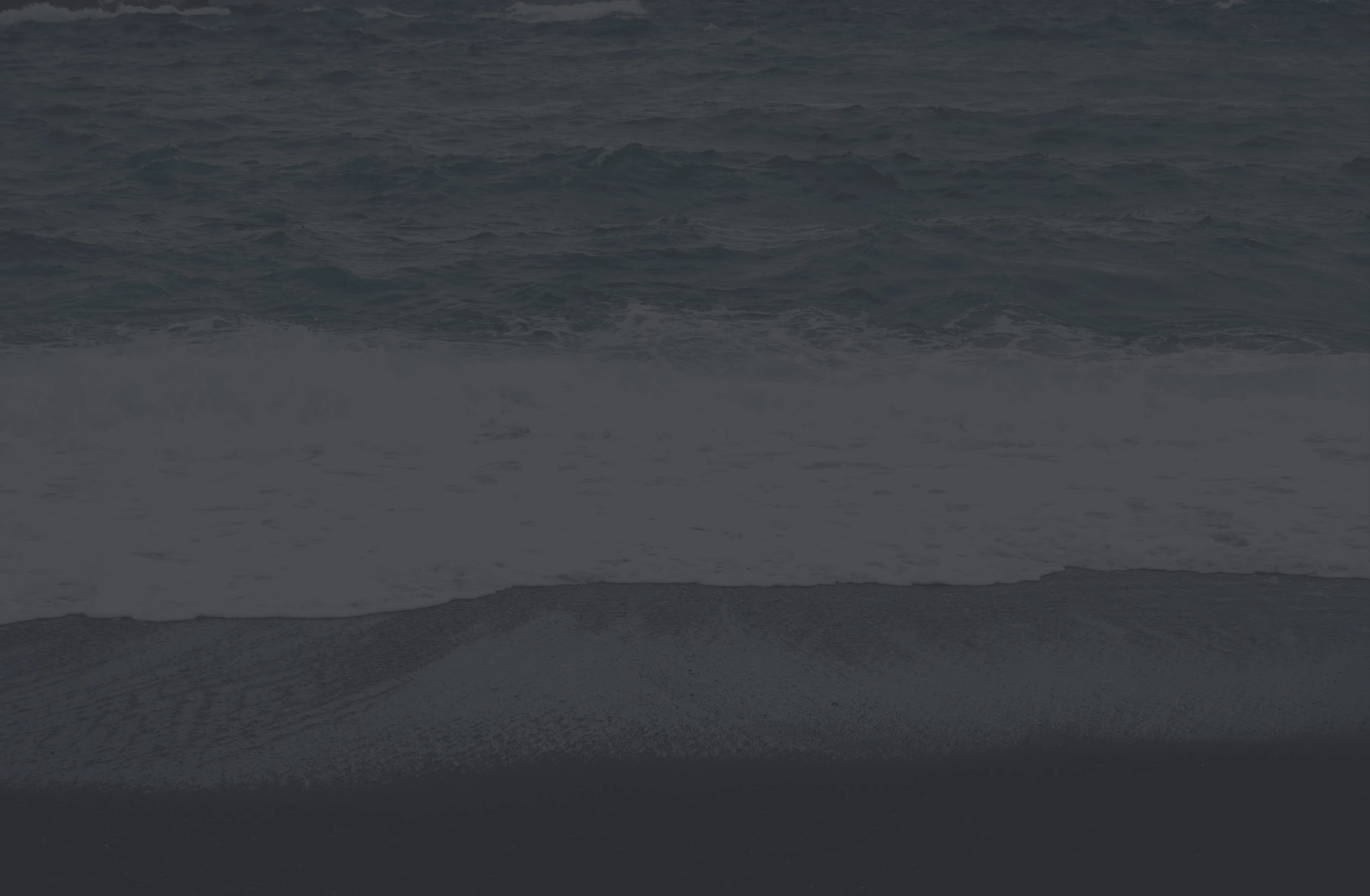 a beach with waves and sand