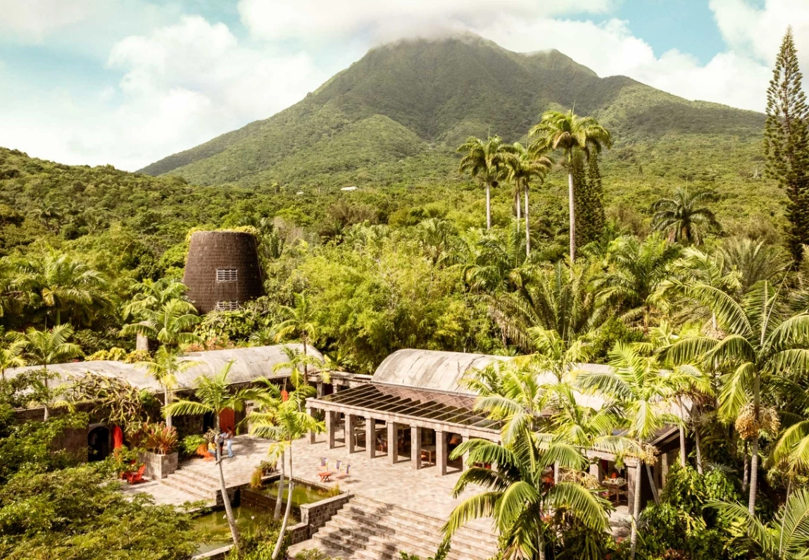 a building surrounded by trees and mountains