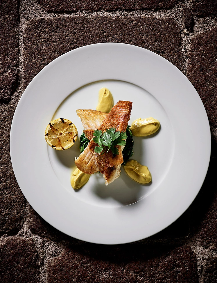 a plate of food on a brick surface