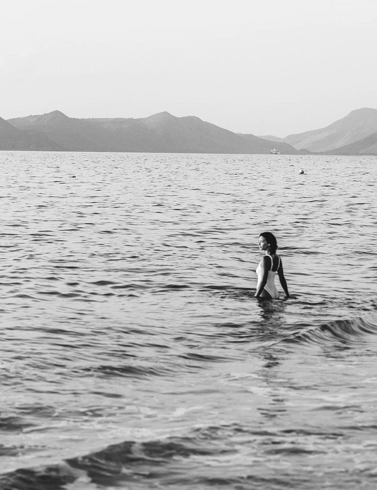 a woman in a white dress in the water