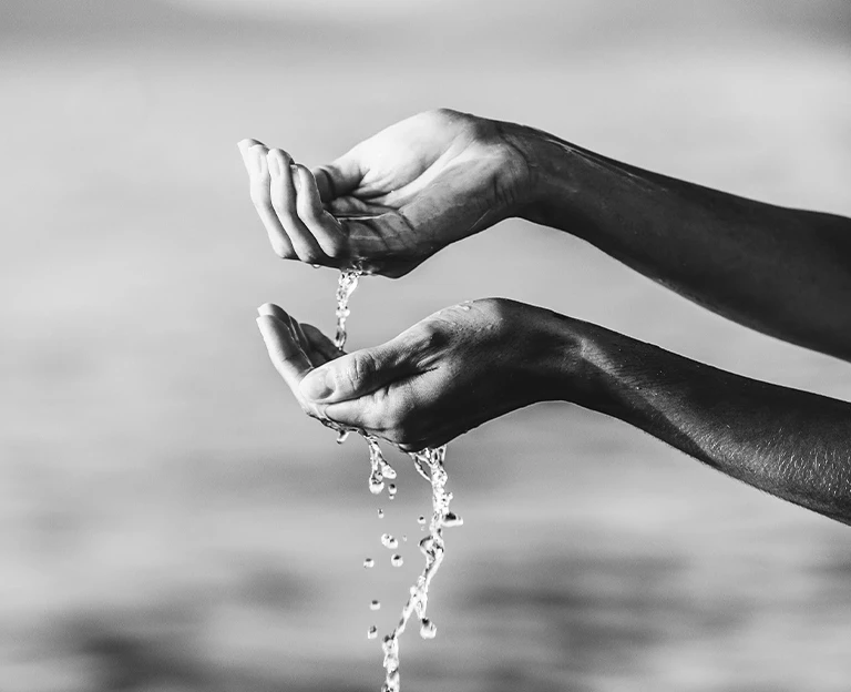 a hands pouring water from the palm of their hands