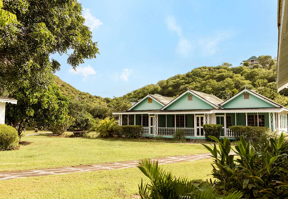 a house with a lawn and trees in the background