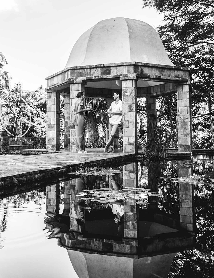 a couple of people standing under a gazebo