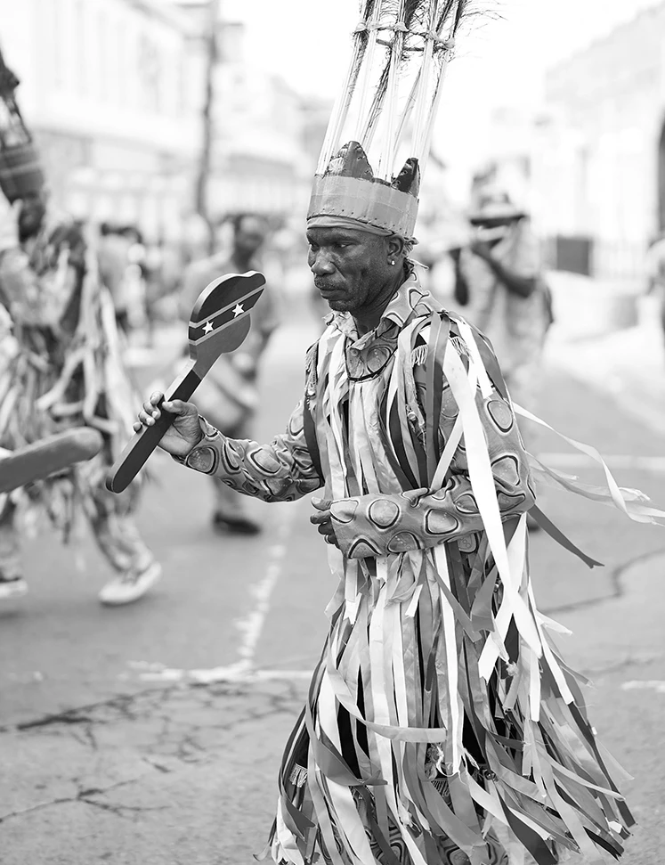 a man in a garment holding a maracas