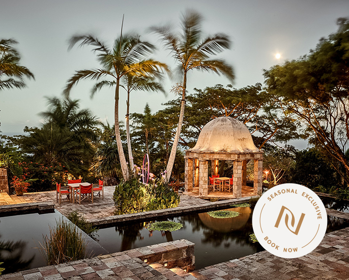 a gazebo with a pool and palm trees