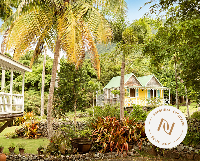 a house with palm trees and a small building