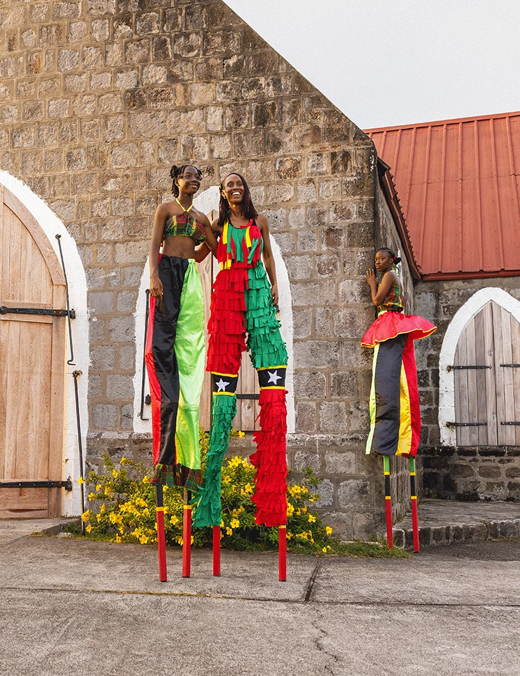 a group of women standing on stilts