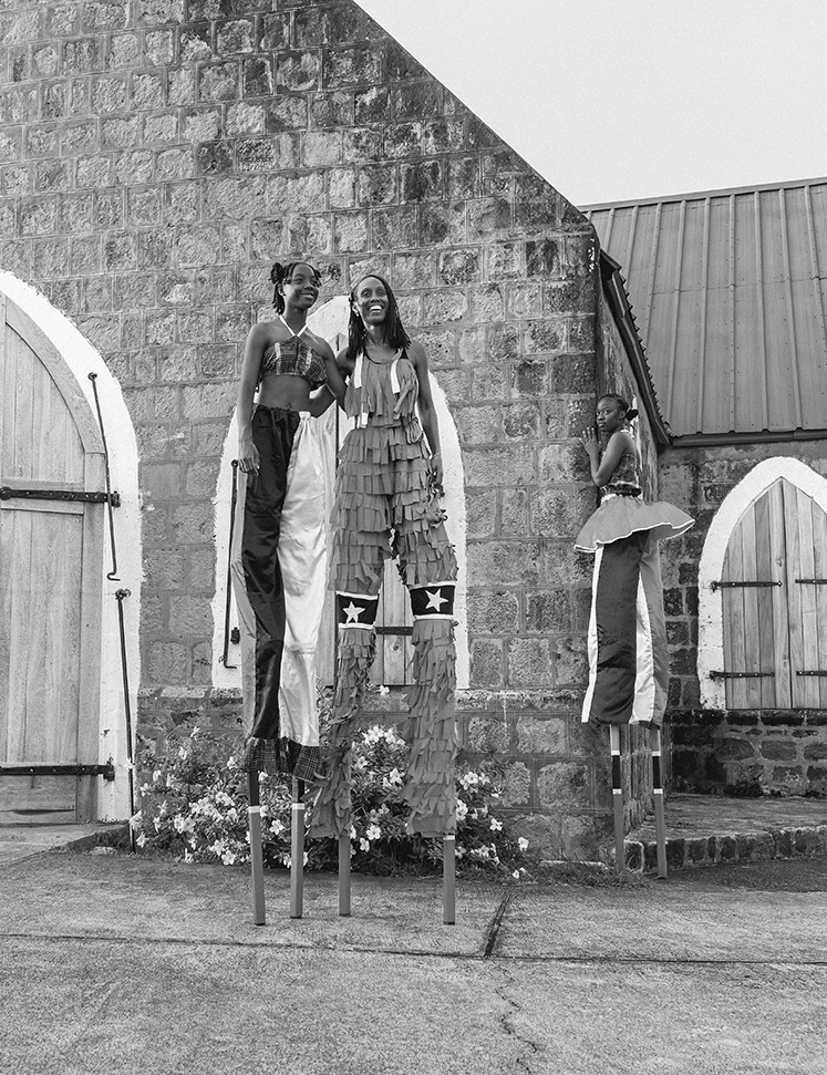 a group of women standing on stilts