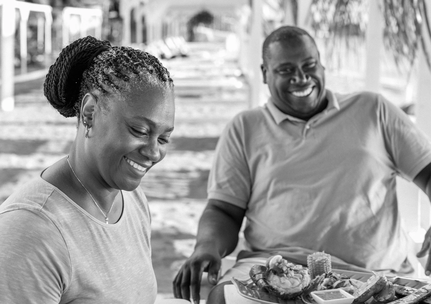 a man and woman smiling at a table