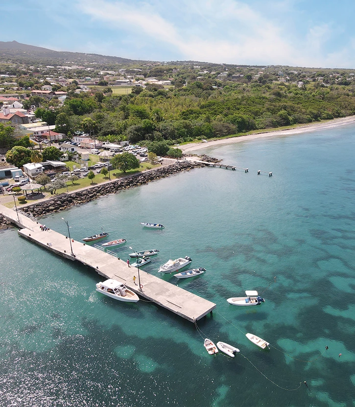 a dock with boats on it and a body of water with a city in the background