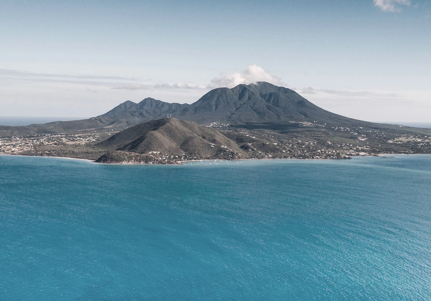 a large island with a mountain in the background