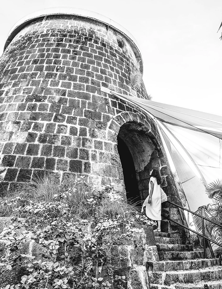 a woman walking up the stairs of a stone building