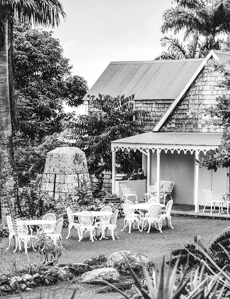 a white table and chairs outside a house