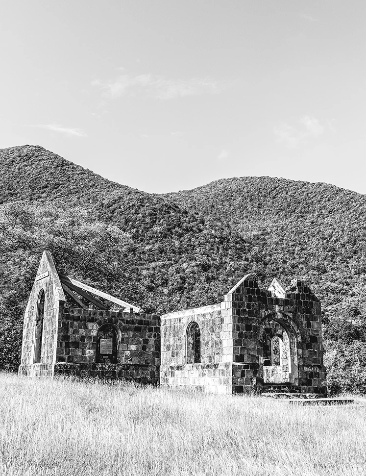 a stone building with a mountain in the background