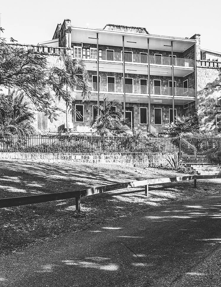 a building with a fence and trees