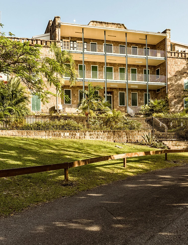 a building with a fence and trees