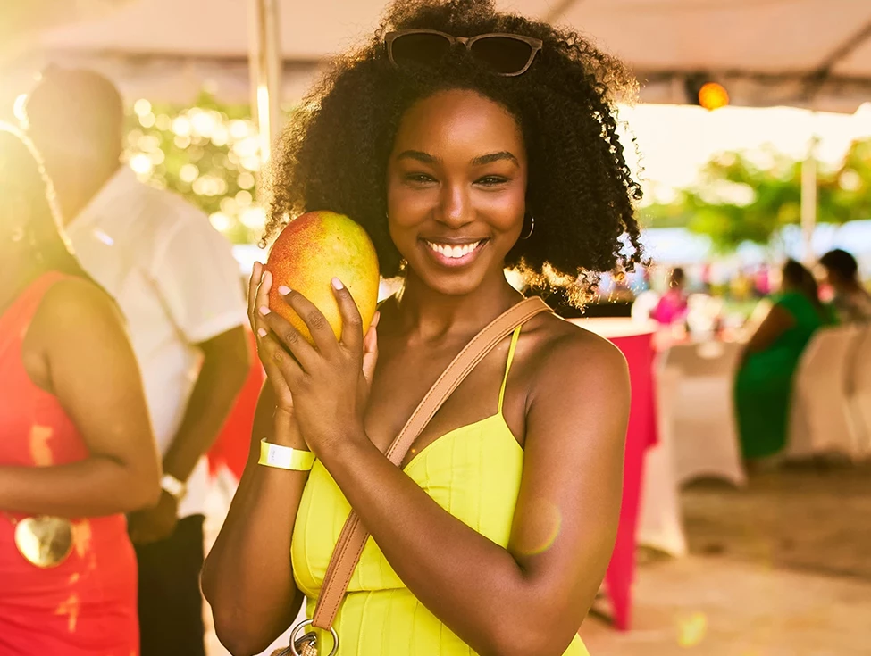 a woman holding a mango