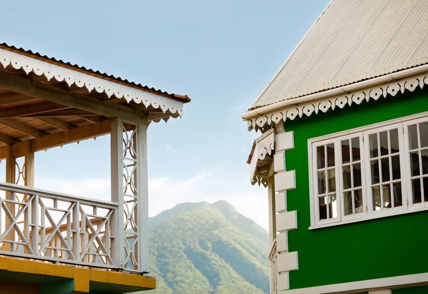 a green and white building with a green roof