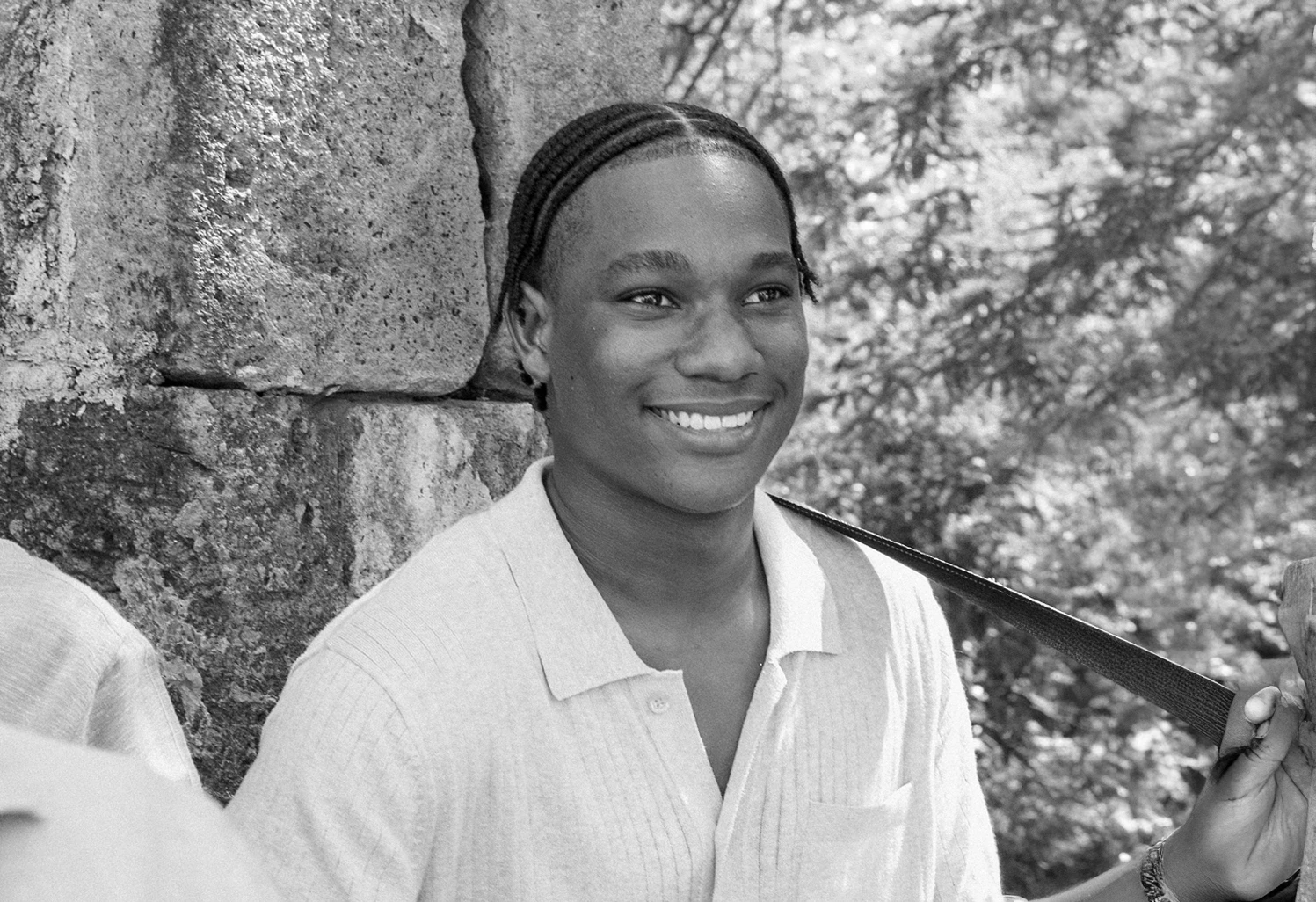 a man smiling in a white shirt