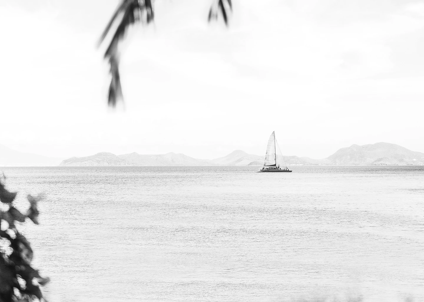 a sailboat in the middle of the ocean