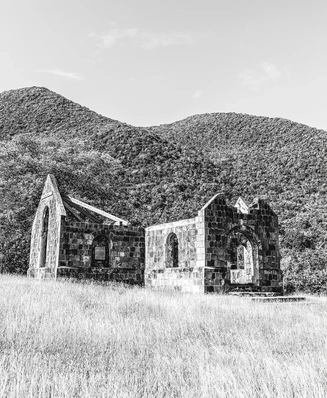 a stone building with a mountain in the background
