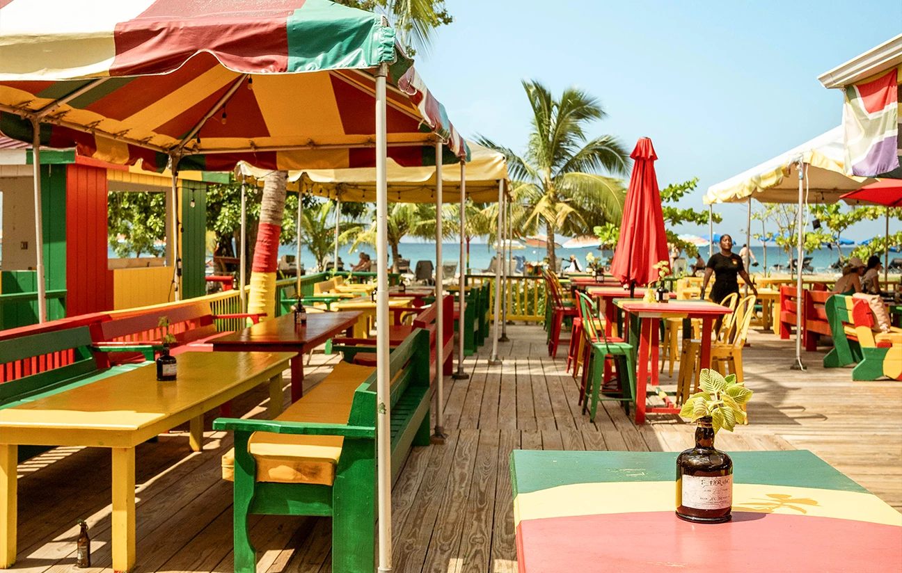 a colorful tables and umbrellas on a beach