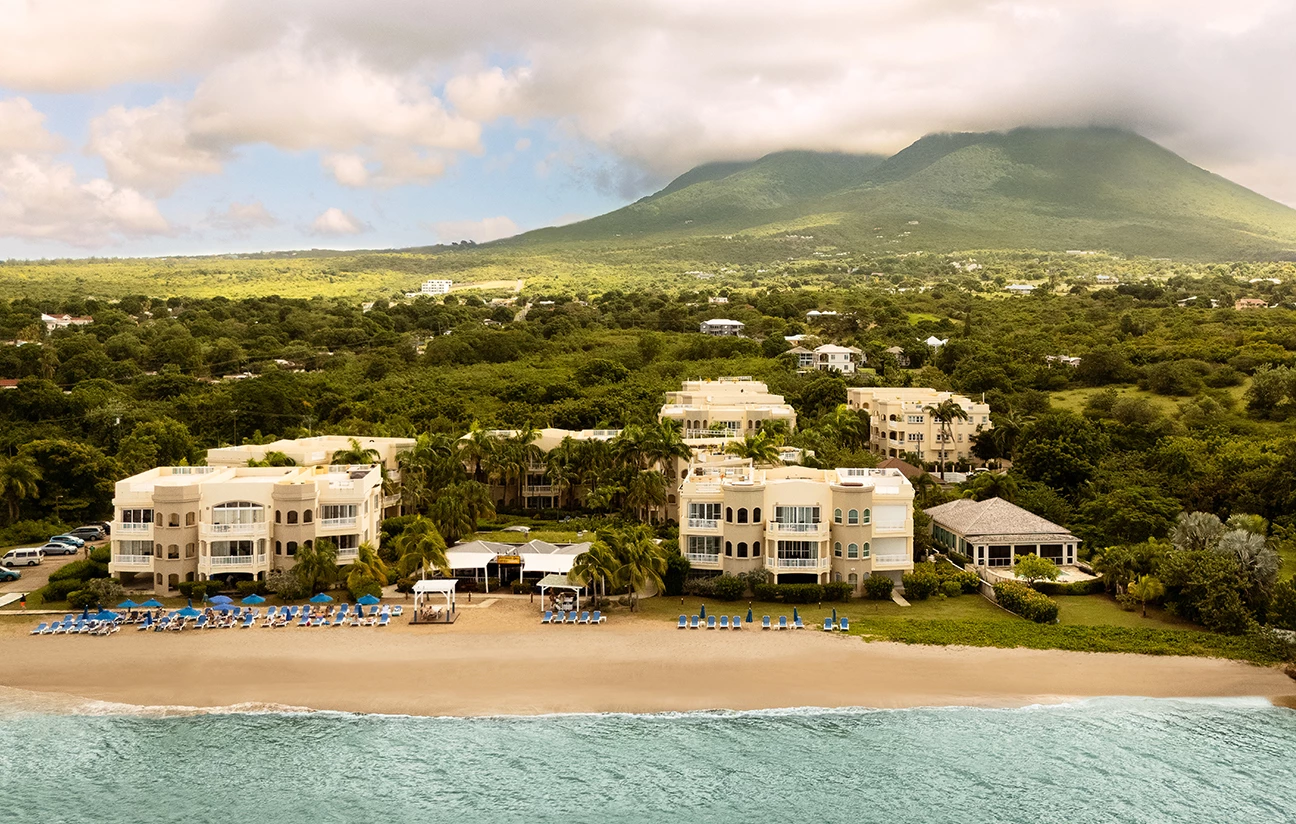 a beach with buildings and trees