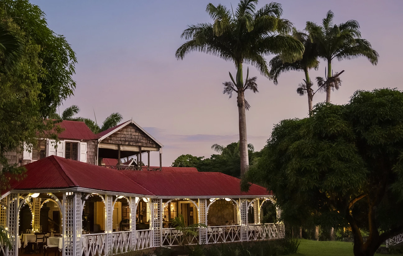a building with palm trees and a lawn
