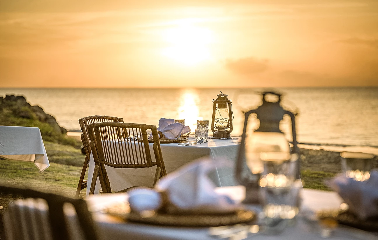 a table set up with a lantern and a plate on it