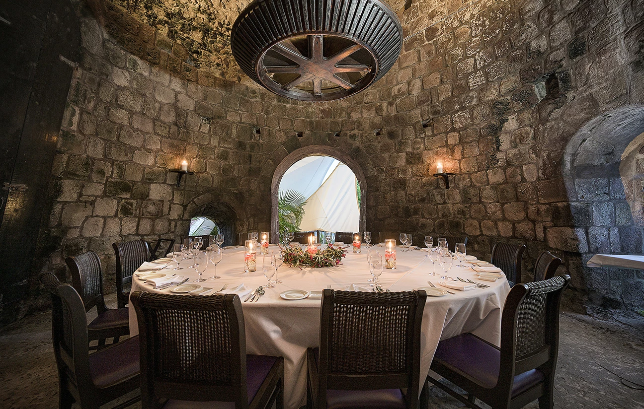 a round table with candles and glasses in a room
