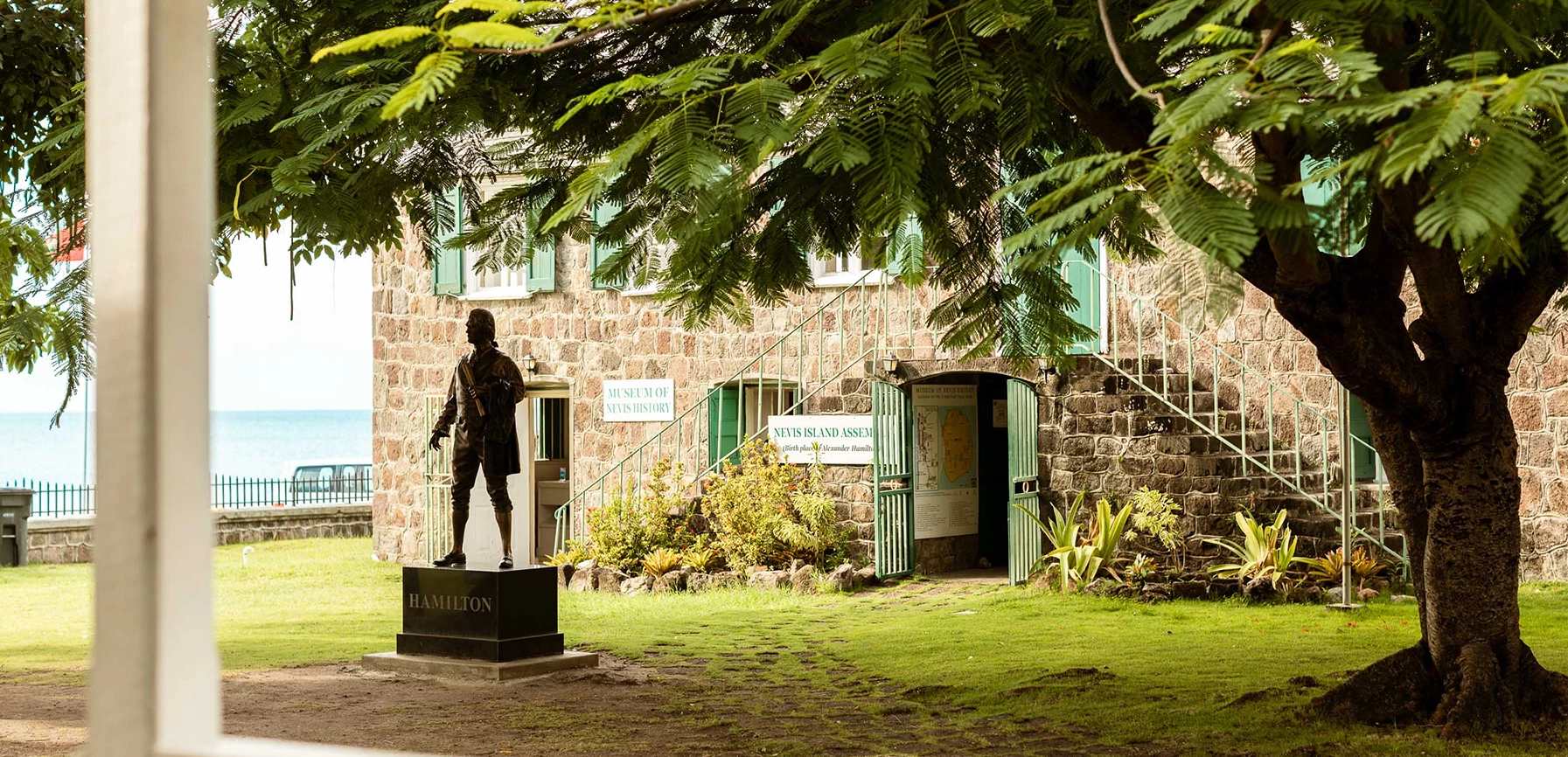a statue of a man on a pedestal in front of a building