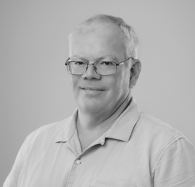 a man wearing glasses and a button up shirt