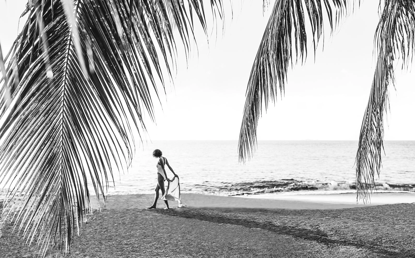 a woman walking on a beach