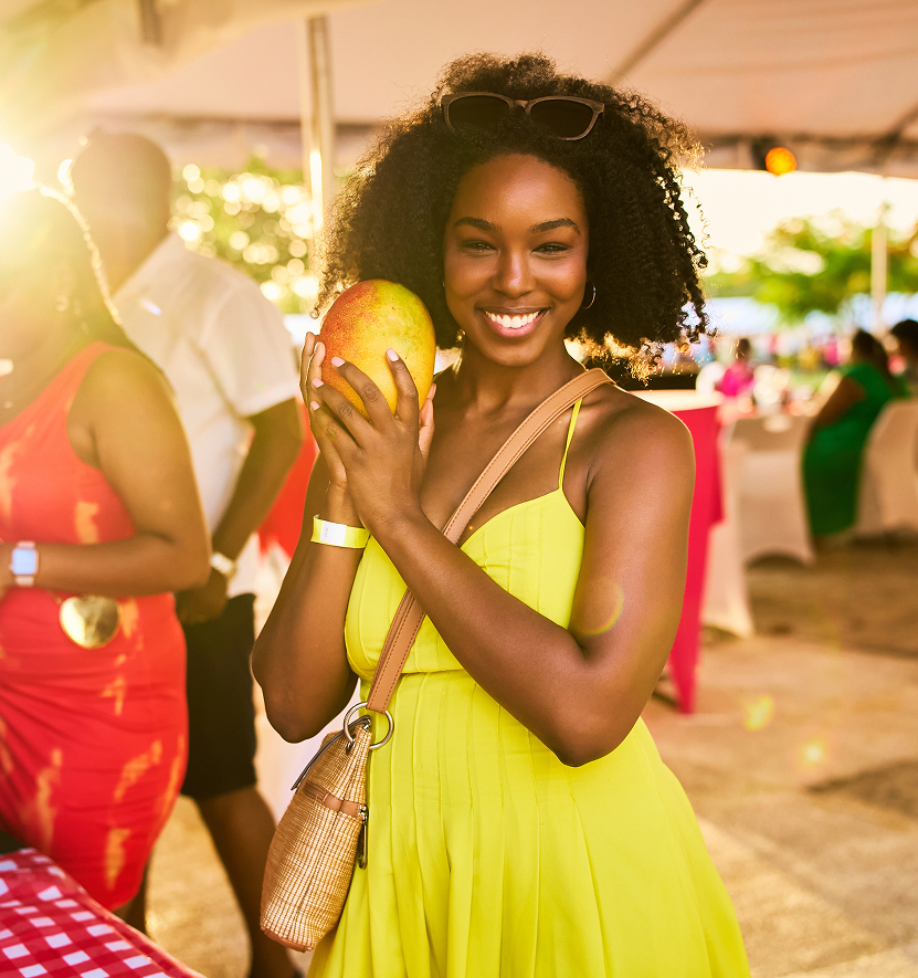 a woman holding a mango