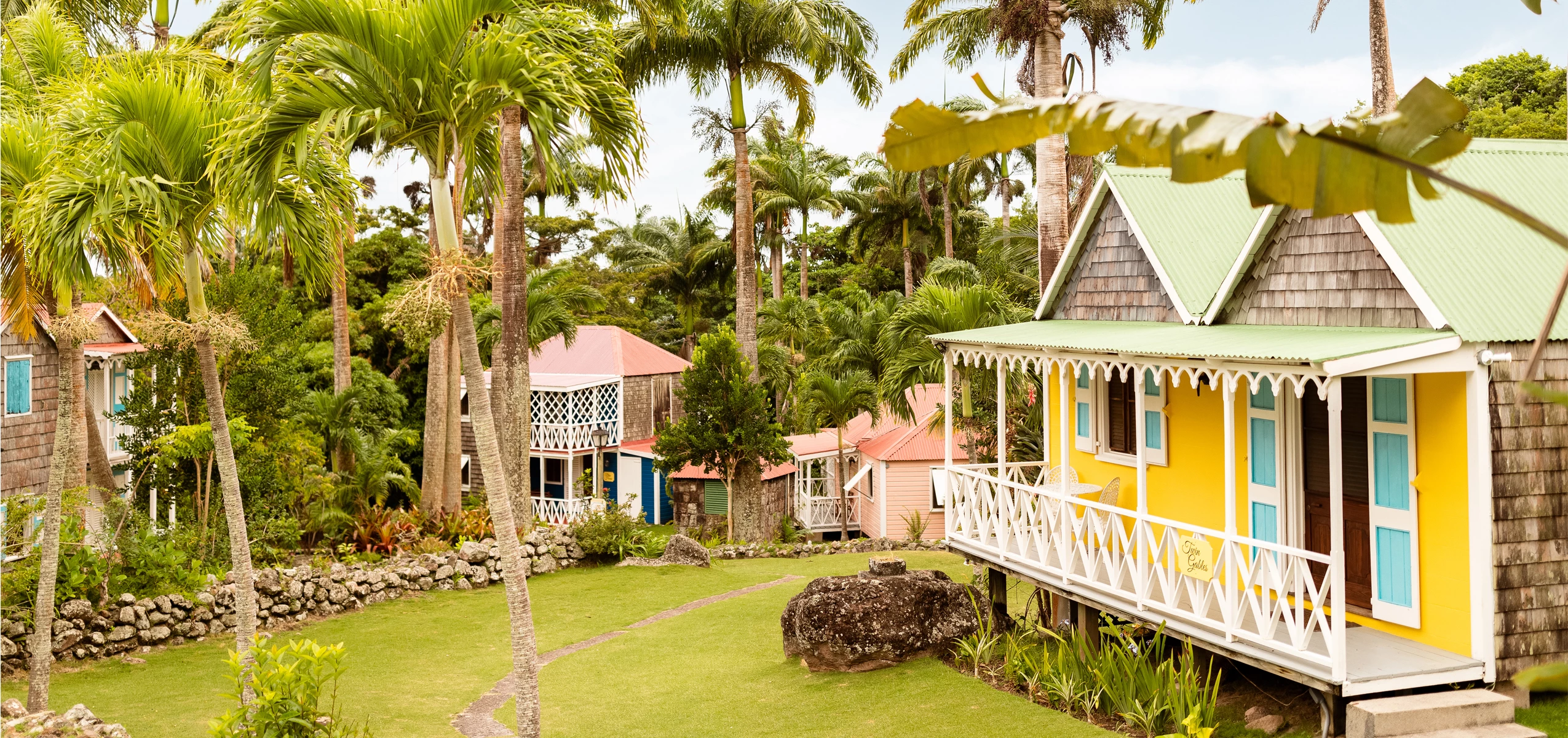 a group of houses with palm trees