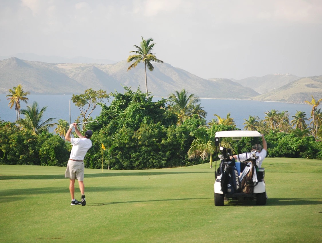 a man swinging a golf club on a golf course
