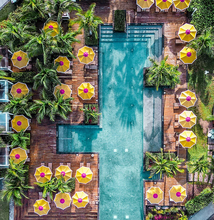 a pool with umbrellas and palm trees