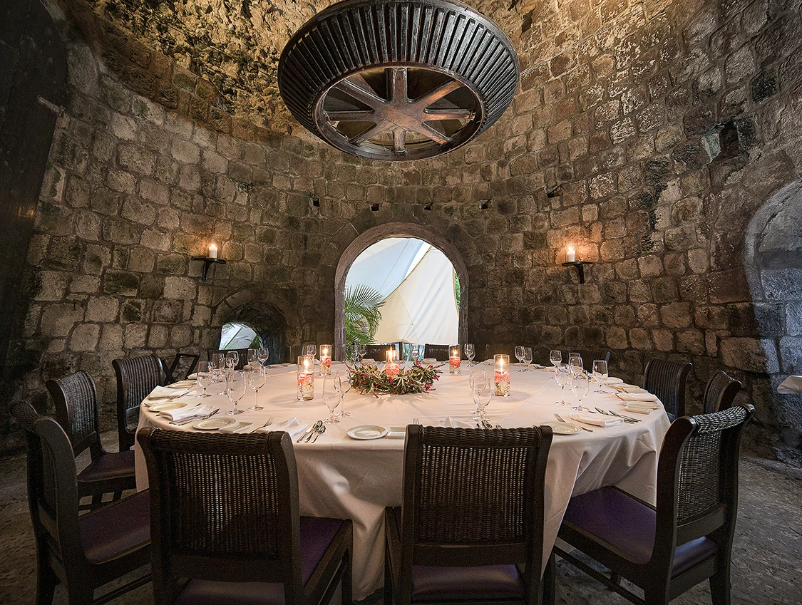 a round table with a white tablecloth and candles on it