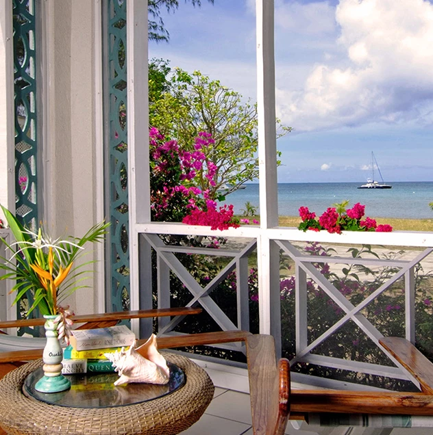 a table with a vase on it and a vase on it with a boat in the background