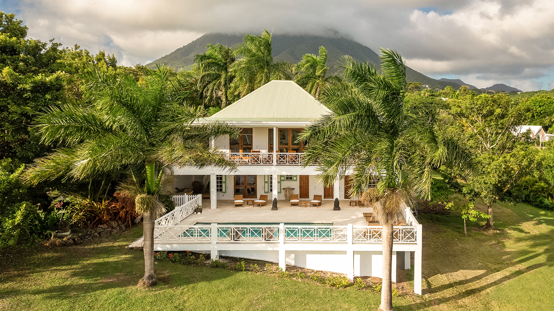 a house with a deck and palm trees