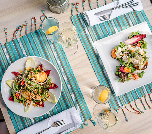 a plate of salad and a glass of wine