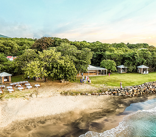 a beach with a group of people and a group of tents