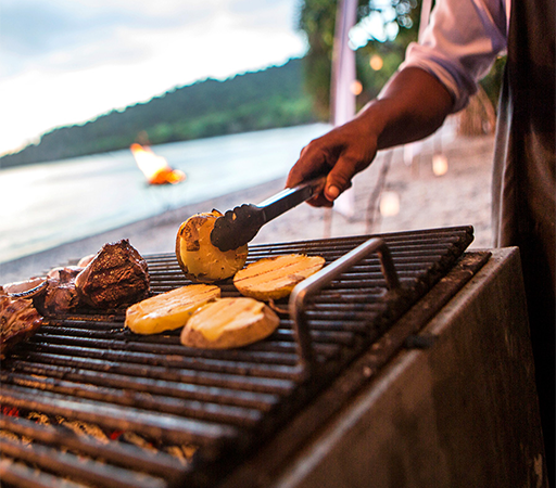 a person cooking food on a grill
