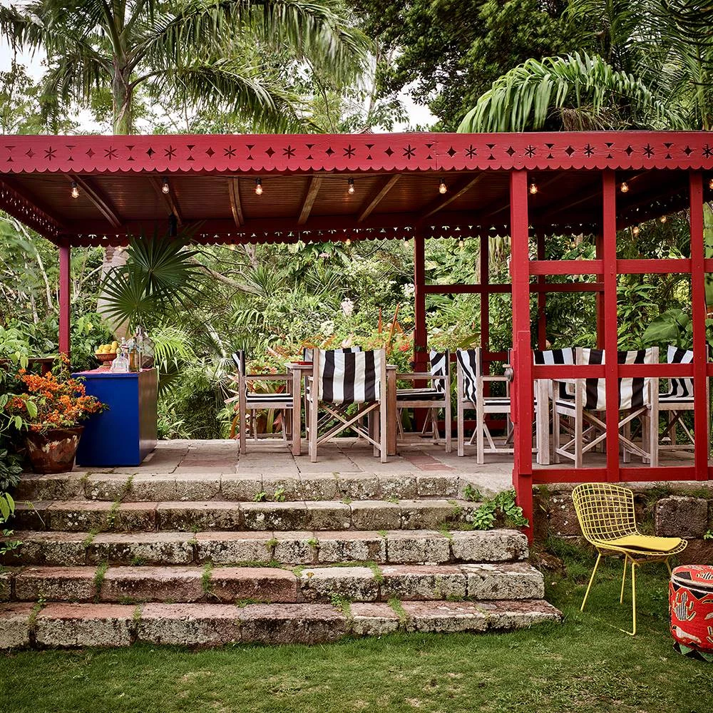 a red covered patio with chairs and a table