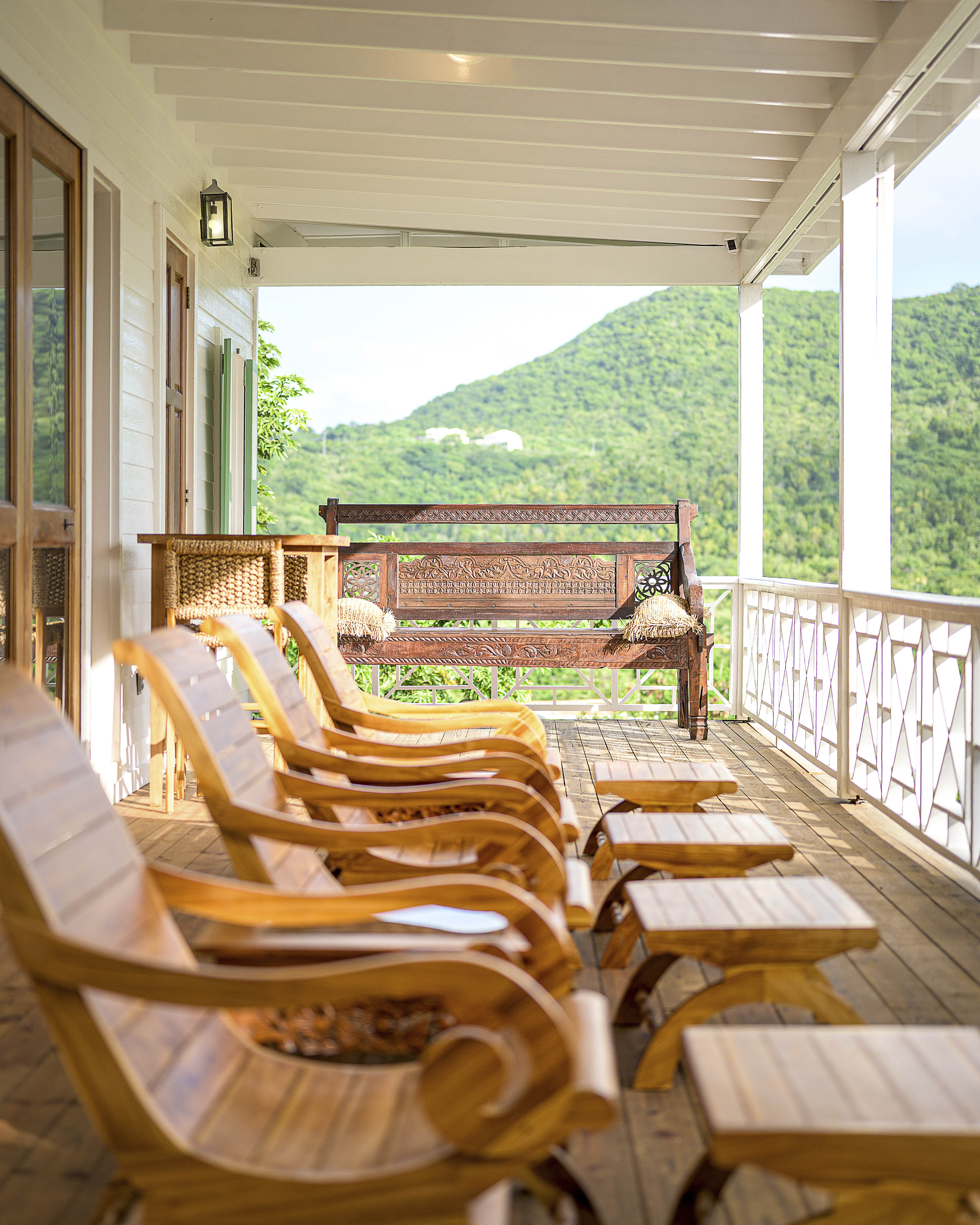 a porch with chairs and tables