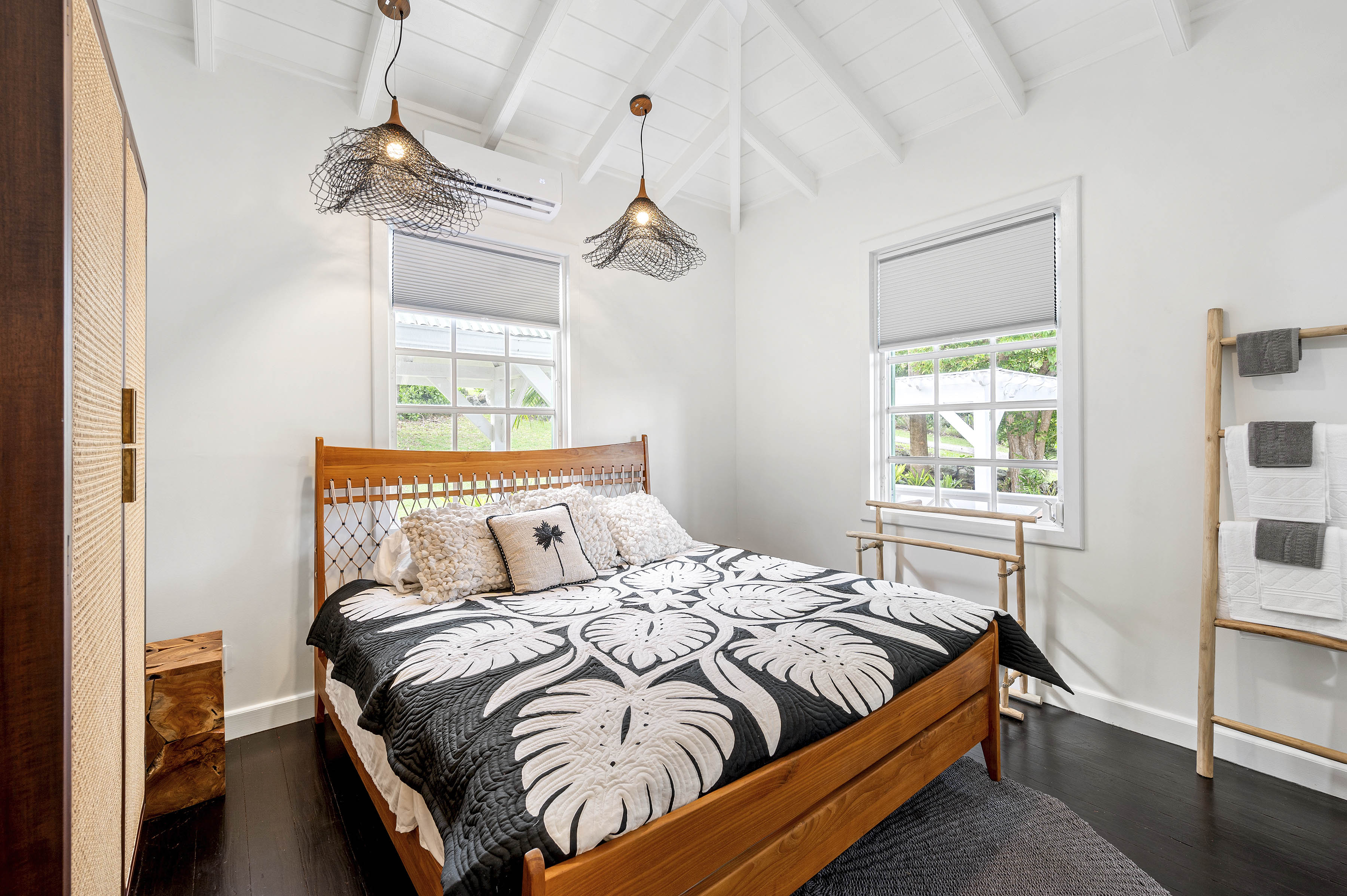 a bed with a black and white cover and pillows
