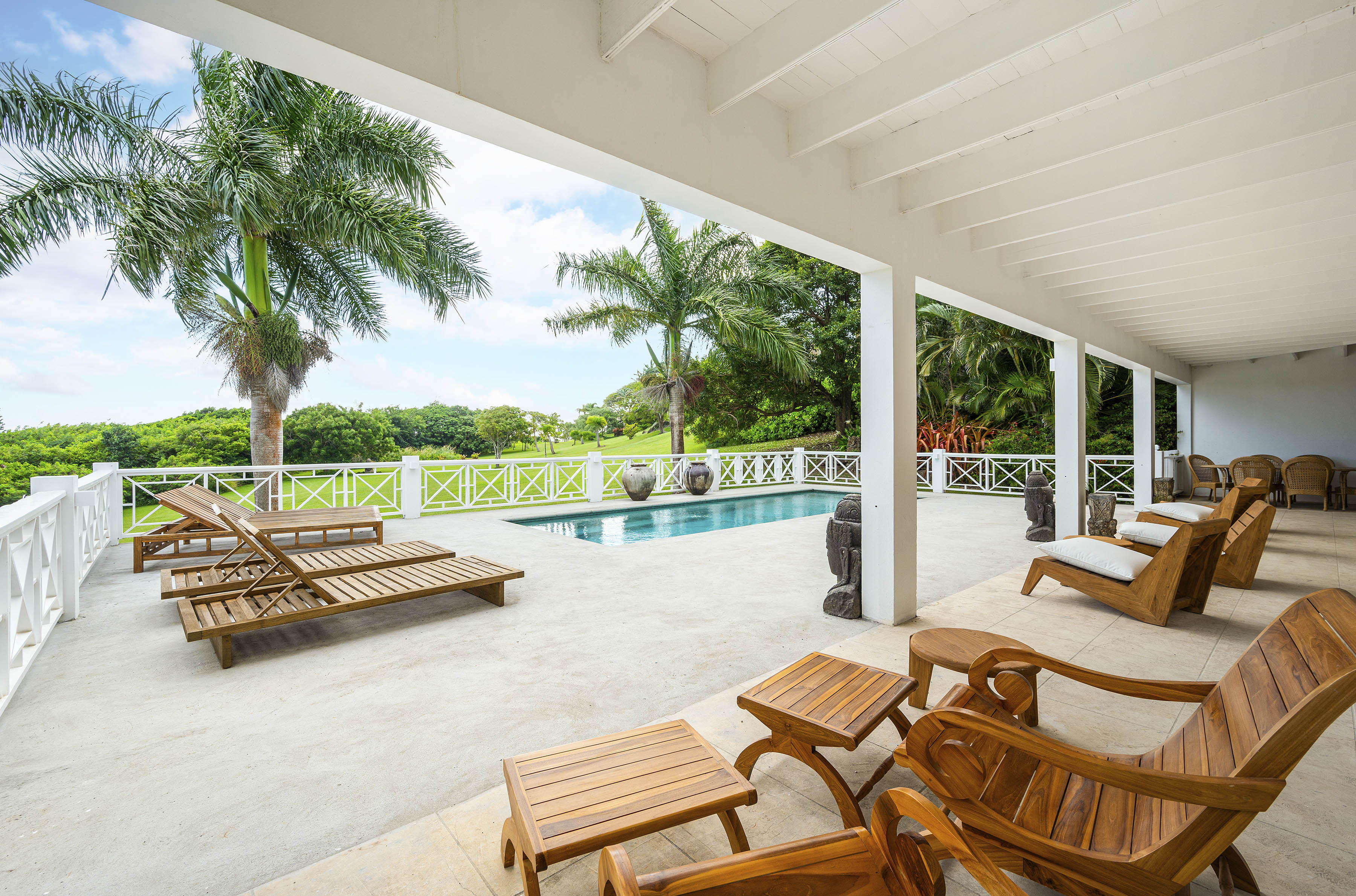 a deck with chairs and a pool