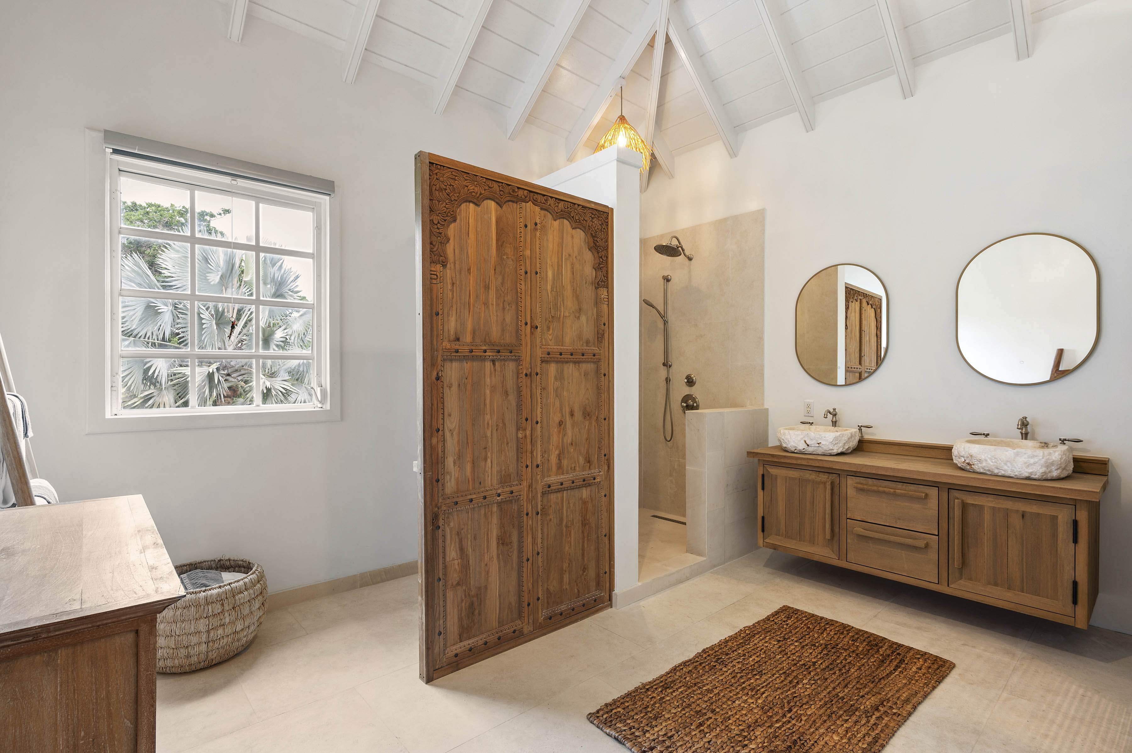 a bathroom with a wood door and a sink